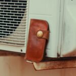 a brown wallet sitting on top of a window sill